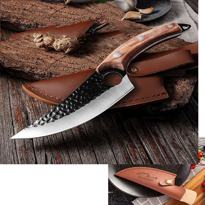 Curved butcher knife with hammered steel blade and wooden handle on leather sheath over rustic wood surface.