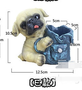 Small beige pug puppy figurine holding blue denim pouch with button closure.