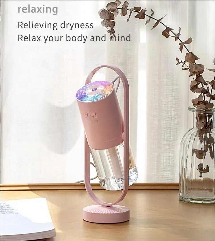 Pink Magic Shadow USB air humidifier with projection night lights on wooden surface.
