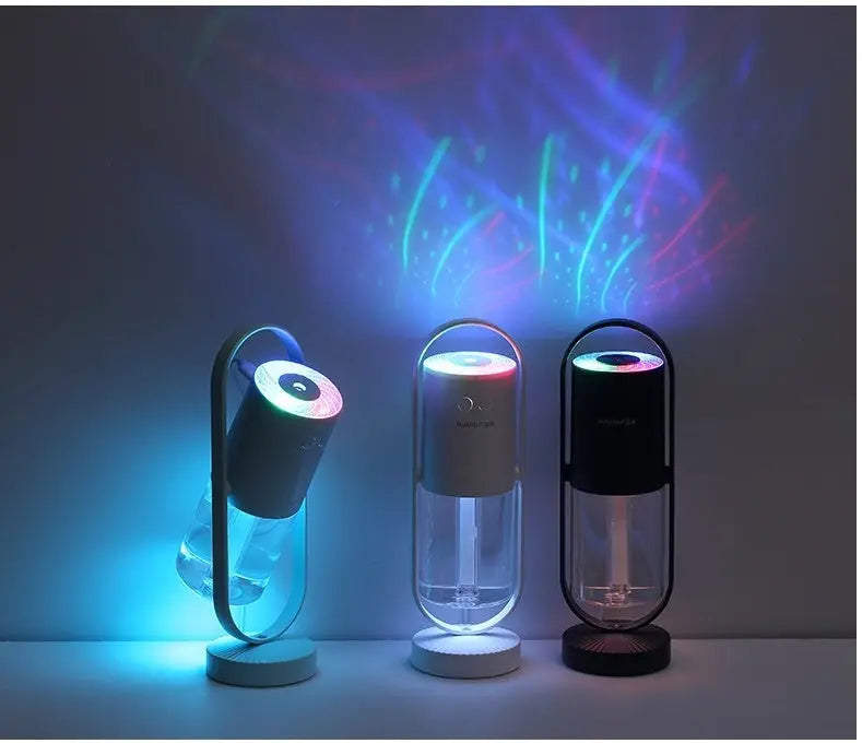 Three Magic Shadow USB air humidifiers in blue, white, and black with colorful projection night lights creating glowing.