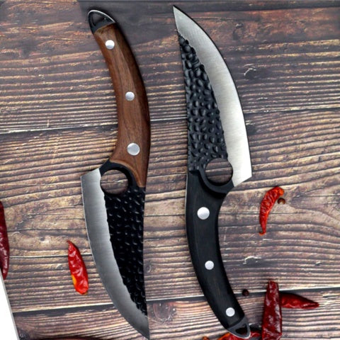 Two meat-cutting boning knives with curved blades, textured black sheaths, and ergonomic wood and black handles on a wooden.