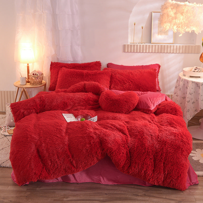 Plush thick fleece red duvet cover set with matching pillowcases and bolster on bed.