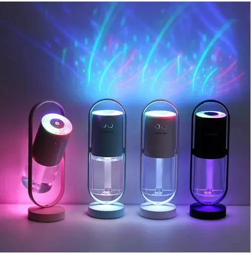 Four cylindrical Magic Shadow USB air humidifiers in blue, white, and black bases, projecting colorful patterned night.