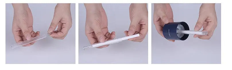 Hands inserting a cotton swab into a black Magic Shadow USB air humidifier vessel.