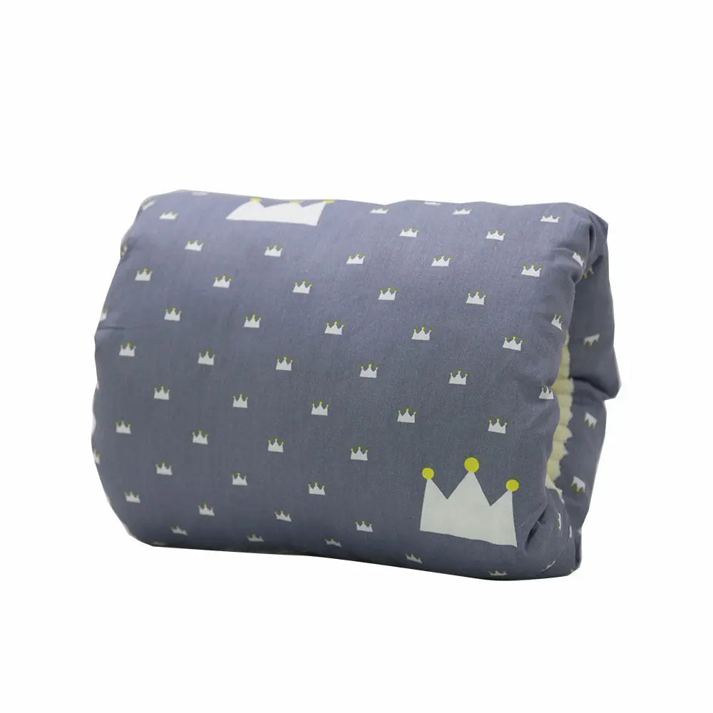 Dark blue nursing arm pillow with small white and yellow crown pattern, soft cotton fabric.