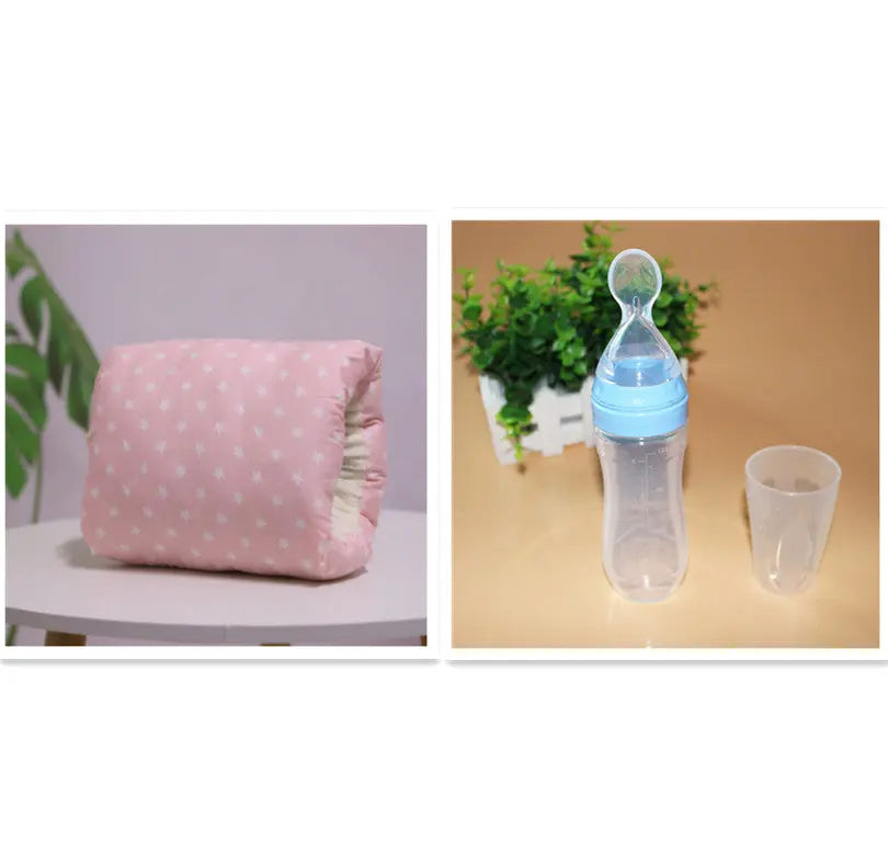 Pink nursing arm pillow with white stars pattern and elastic band on white surface.