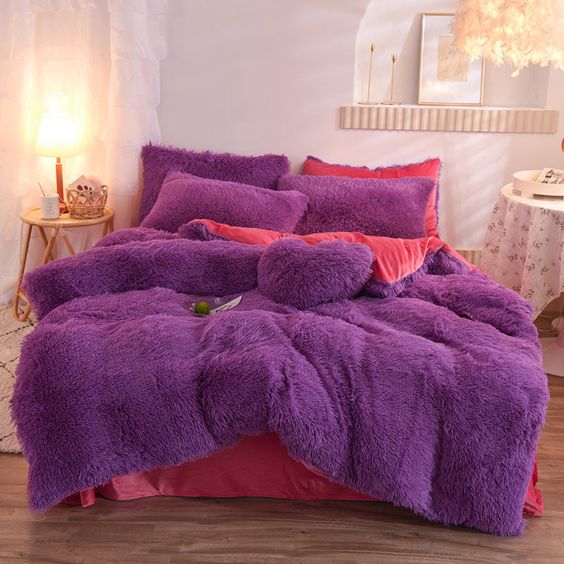 Plush thick fleece duvet cover and matching pillowcases in rich deep purple on bed with coral sheets.