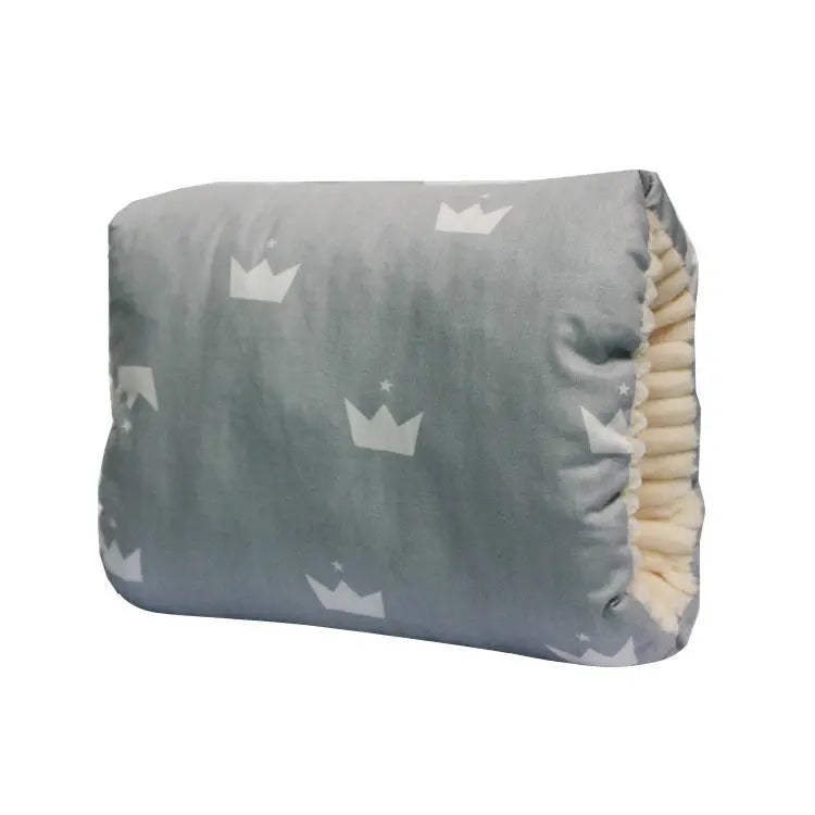Gray nursing arm pillow with white crown patterns and soft cream ribbed interior lining.
