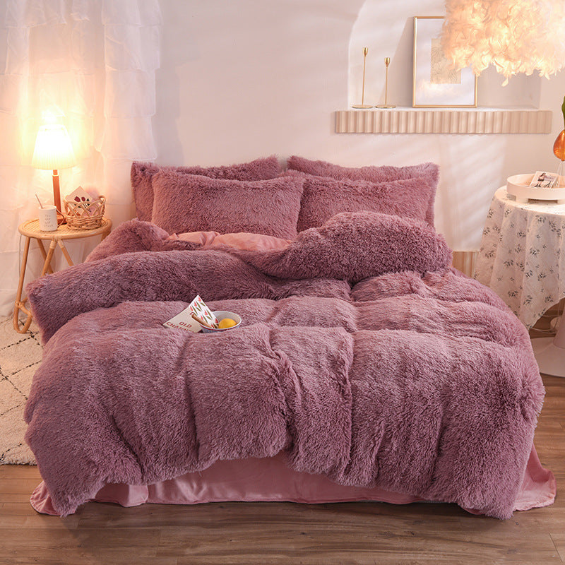Plush thick fleece duvet cover and matching pillows in dusty pink with shaggy texture on a bed in cozy room setting.