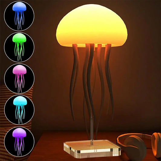 Orange glowing jellyfish-shaped LED lamp with black tentacles on clear square base.