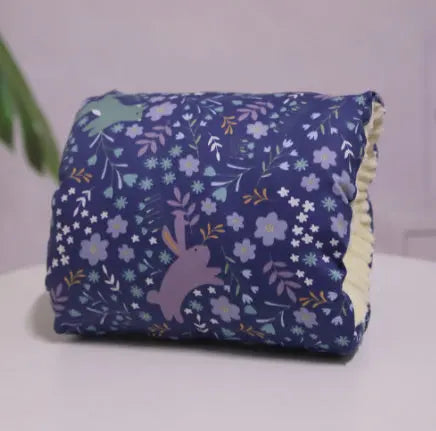 Deep blue nursing pillow with pastel floral and rabbit pattern, cotton fabric cushion.