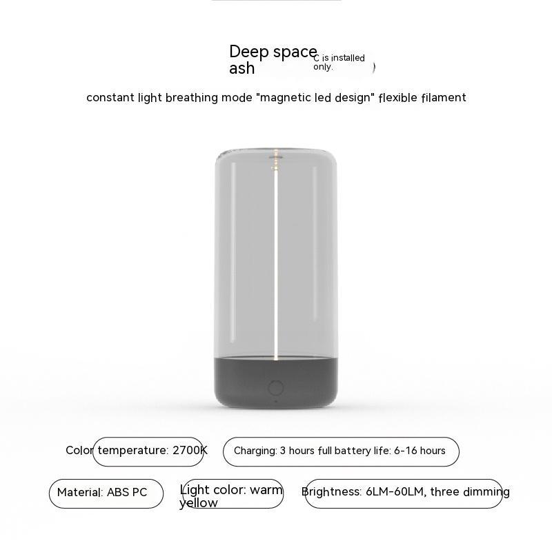 Transparent cylindrical LED camping light with dark gray base and flexible filament inside.