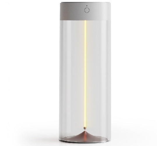 Transparent cylindrical portable LED camping light with dark grey top and thin vertical warm light strip.