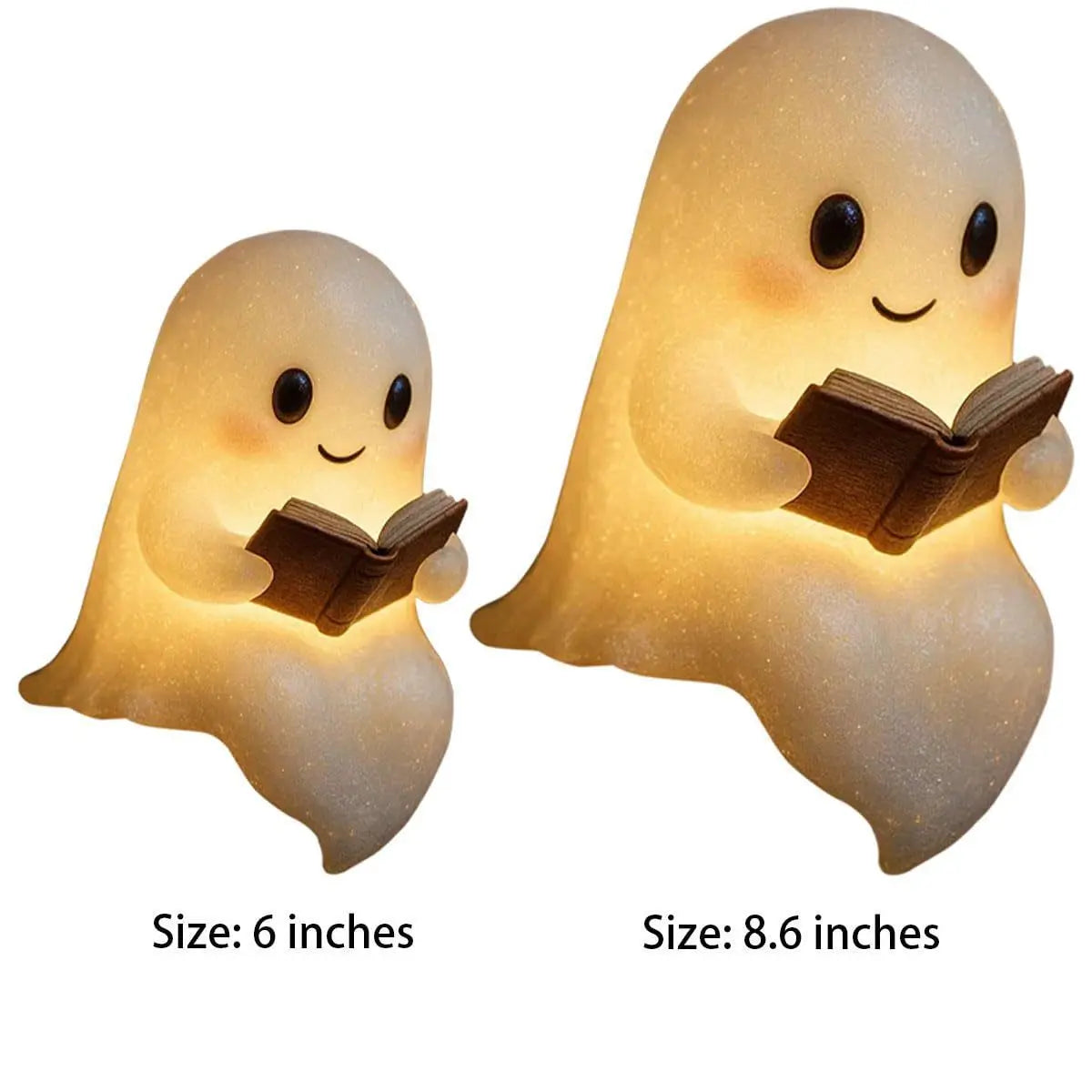 Small and medium smiling ghost-shaped LED night lights holding open books emitting warm light.