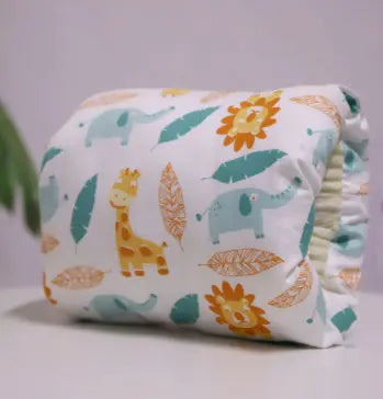 Beige nursing arm pillow with cartoon giraffes, elephants, leaves, and sunflowers pattern.