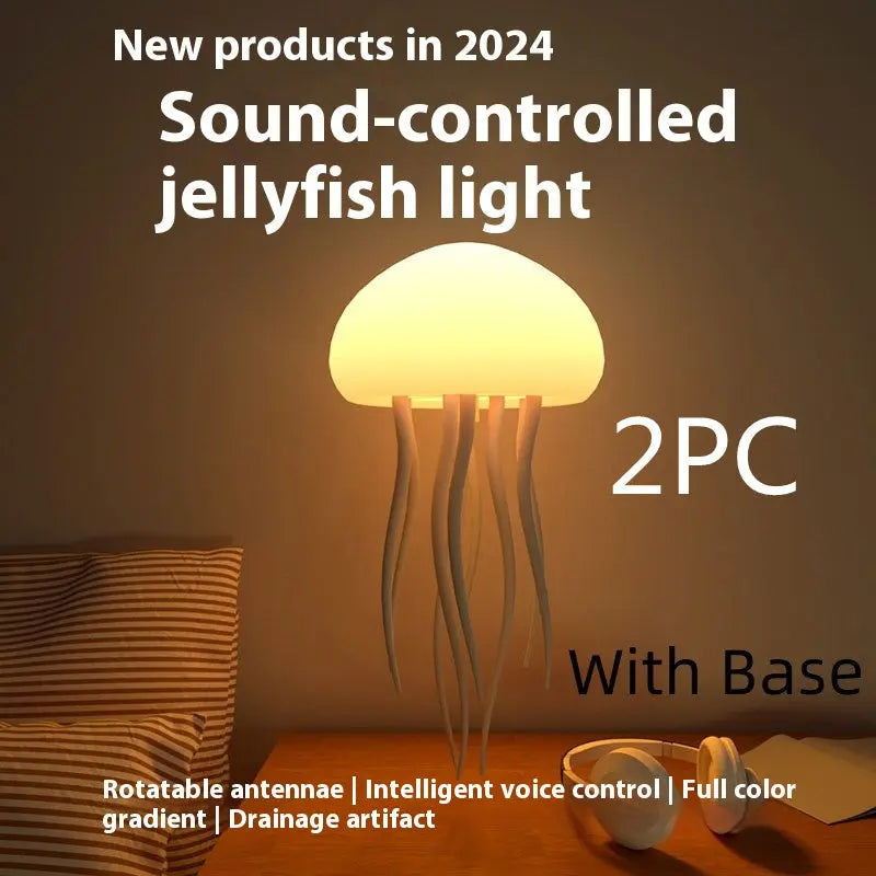 Two warm yellow LED jellyfish mood lamps with bases glowing on a dark surface.