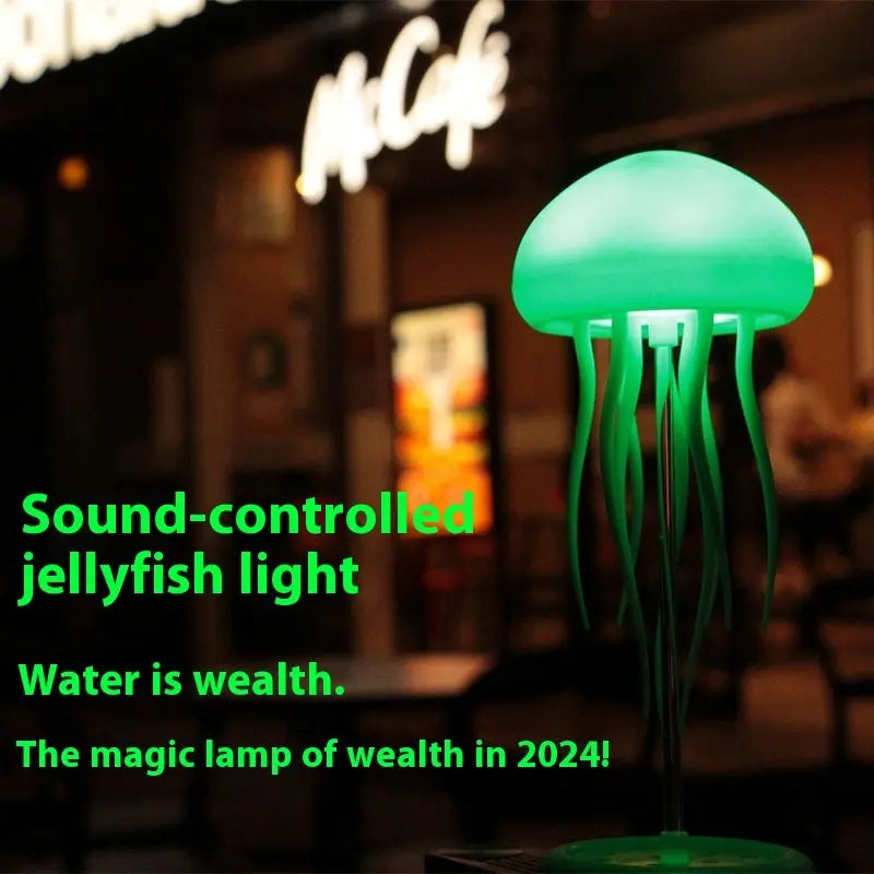 Green glowing LED jellyfish mood lamp with tentacles hanging on a black stand against blurred night background.