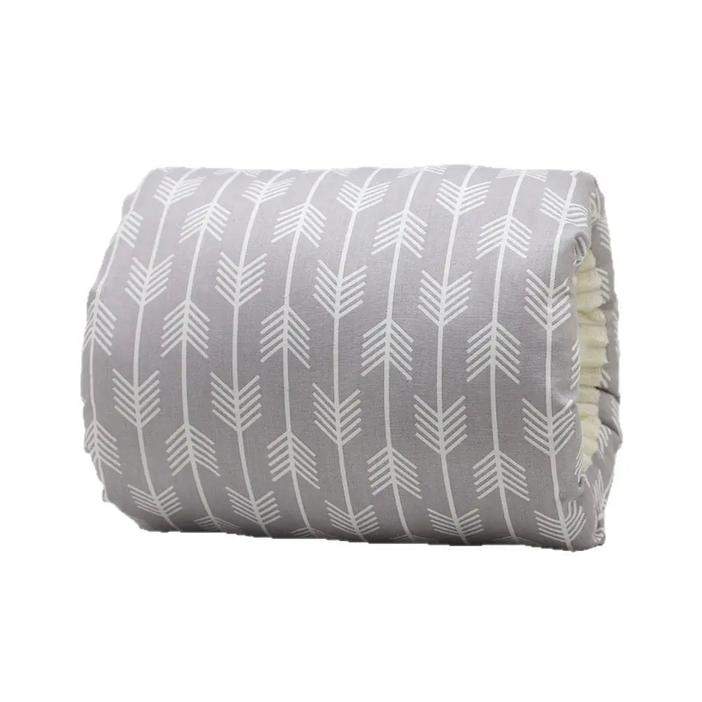 Gray nursing arm pillow with white arrow pattern and soft cotton fabric.