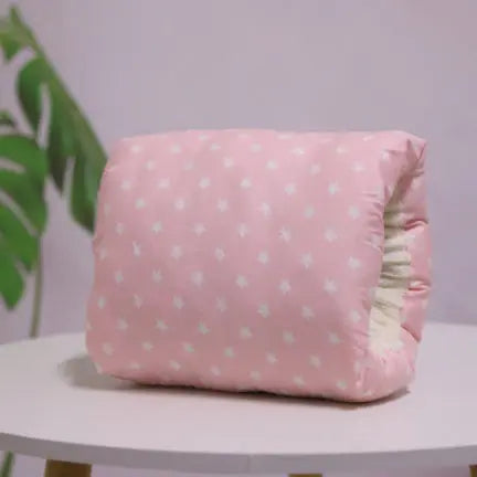 Pink nursing arm pillow with white star pattern and soft cotton fabric cover.
